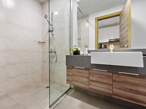 a bathroom with a sink and a shower at Spacious Studio With A Sofa Bed In JVC in Dubai