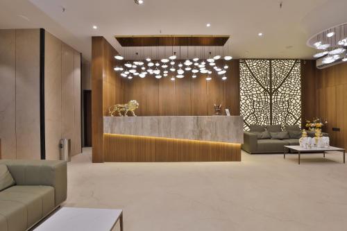 a lobby with a reception desk in a building at Hotel Elements Surat in Surat