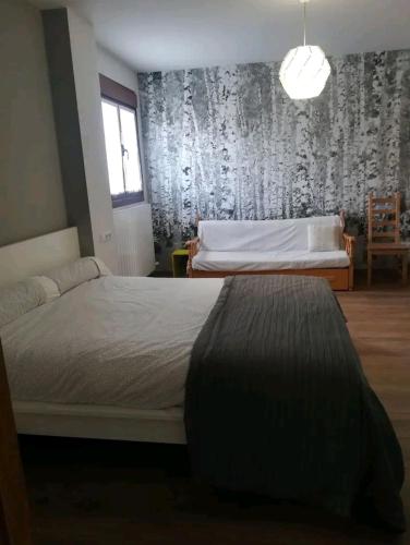 a bedroom with a bed and a window and a wall at Abaunza enea in Erenchun