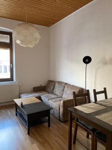 a living room with a couch and a table at Unterkunft in Köln - Nähe Messe und Flughafen in Cologne