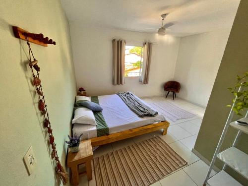 Un pat sau paturi într-o cameră la Kitnet na Vila de Manguinhos