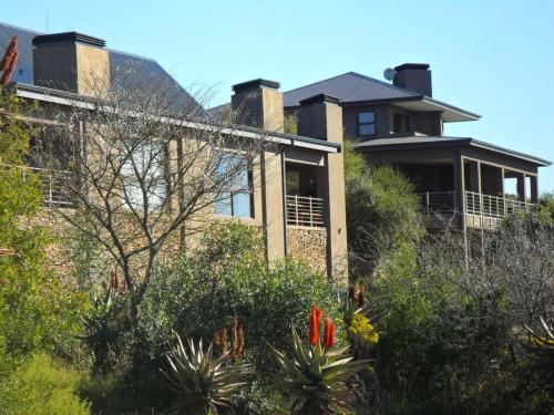 a house on top of a hill with plants at Stonehill River Lodge by Dream Resorts in Buffeljagsrivier