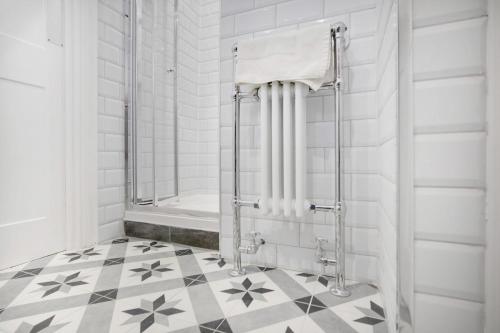 a bathroom with a shower and a tiled floor at Urban Elegance - Luxe 1-Bed Haven in Hartlepool in Hartlepool