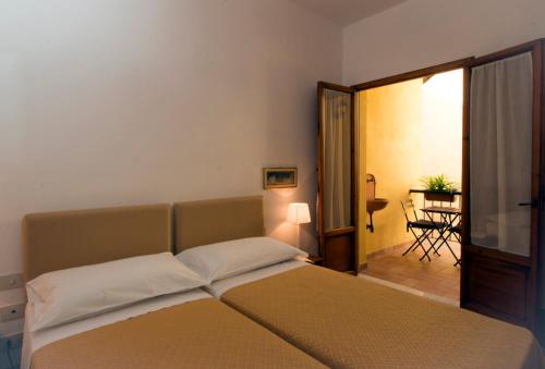 a bedroom with a bed and a room with a table at Dimora Pieri in Florence
