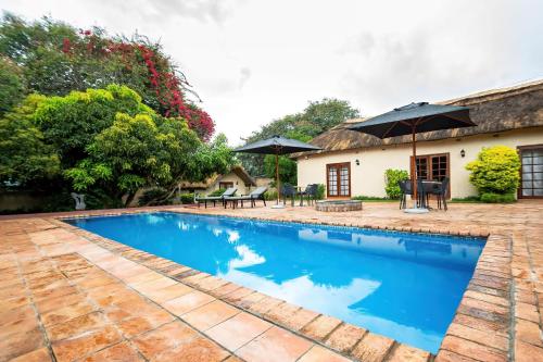 a swimming pool in front of a house at 2 bed apartment with pool - 2126 in Victoria Falls