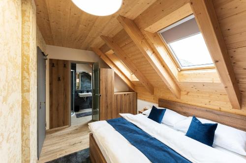 a bedroom with a large bed in a wooden room at Penzion Nad Pavlovem in Pavlov