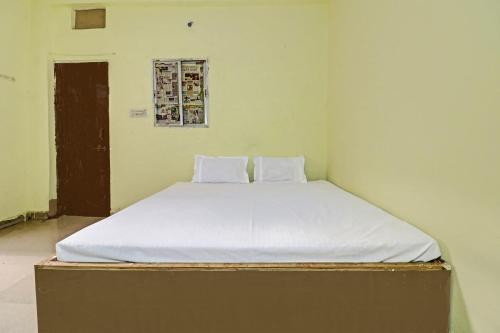 a bed with two pillows on it in a room at SPOT ON 81062 Moonlight Hotel in Bhilai