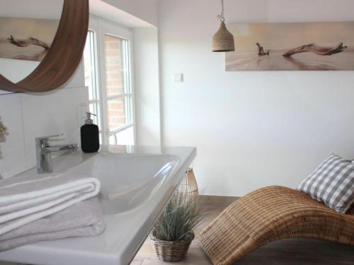 a white bathroom with a sink and a mirror at Cathedral day "Hygge" in Kronsgaard