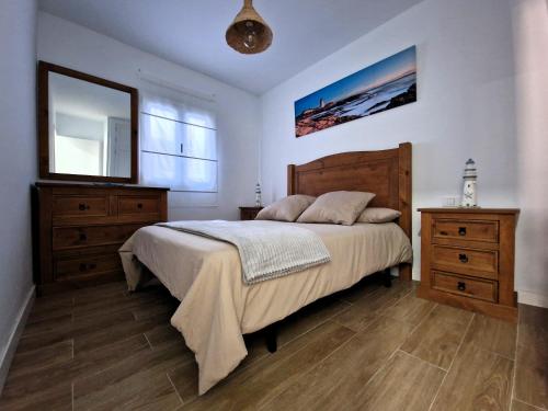 a bedroom with a bed and two dressers and a mirror at MALVASIA 5 in Famara