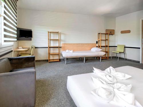 a hotel room with two beds and a television at ibis budget Katowice Centrum in Katowice