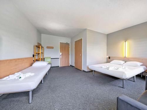a hospital room with two beds in it at ibis budget Katowice Centrum in Katowice