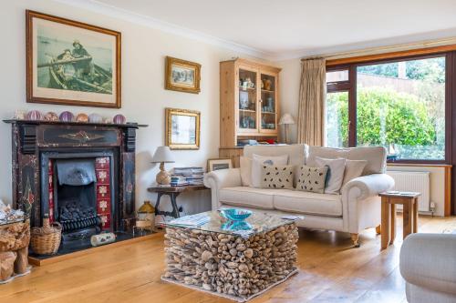 a living room with a couch and a fireplace at High quality detached house with parking St. Ives in St Ives