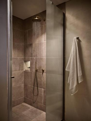 a bathroom with a shower with a glass door at Pierros Verde in Lithakia