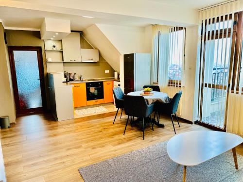 a kitchen and dining room with a table and chairs at PANORAMA APARTMENT in Montana