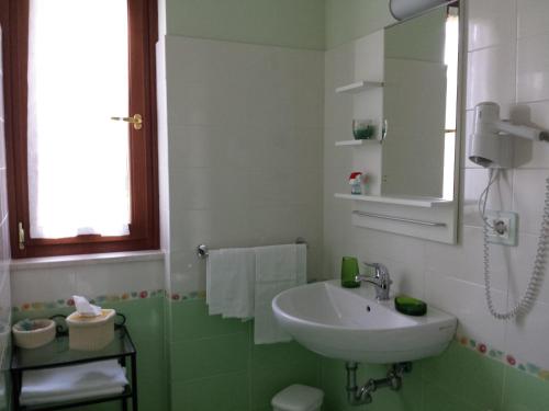 a bathroom with a sink and a mirror at Garden B&B in Arezzo