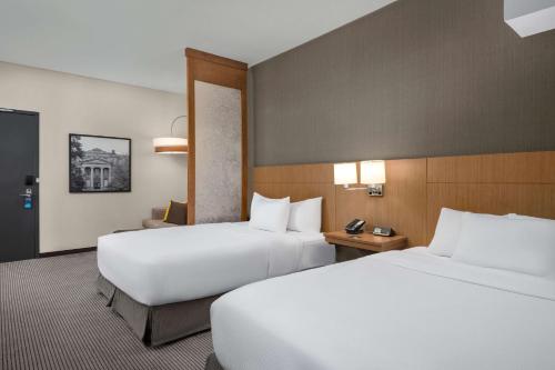 two beds in a hotel room with two beds sidx sidx sidx at Hyatt Place Iowa City Downtown in Iowa City