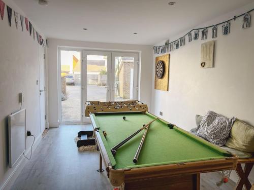 a living room with a pool table in it at Beachcomber in Camber