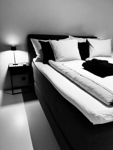 a black and white bedroom with a large bed at Design Flat Hidden Pearl Davos in Davos