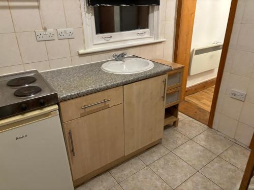 a kitchen with a sink and a counter top at Stay in Islington/Arsenal in London