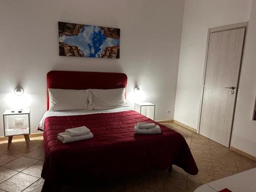 a bedroom with a bed with two towels on it at Al Cortiletto in Palermo