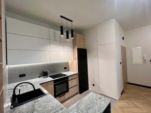 a kitchen with a sink and a counter top at Apartament Zdrojowy Zakątek in Busko-Zdrój