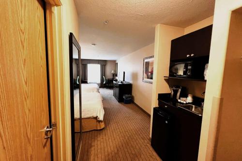 a hotel room with a bed and a sink at Ramada by Wyndham Prince Albert in Prince Albert