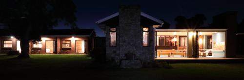 a home at night with the lights on at Gemstone Farm in Plettenberg Bay