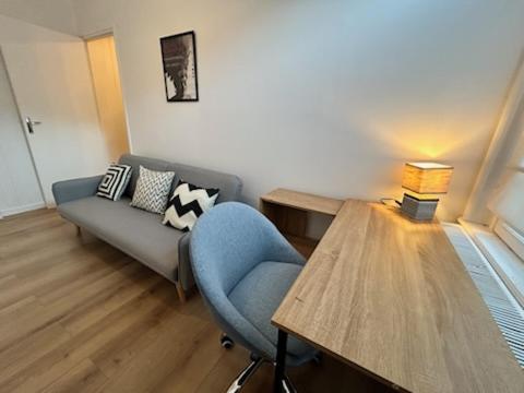 a living room with a couch and a table at Maison Lille à 50m du métro in Lille