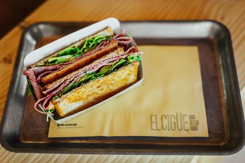 a sandwich on a tray on a table at Hostal La Cigüeña in Portinatx
