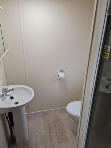 a bathroom with a sink and a toilet at 28 Oaklands in Porchfield
