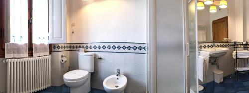 a bathroom with two toilets and a sink and a urinal at Dimora Pieri in Florence