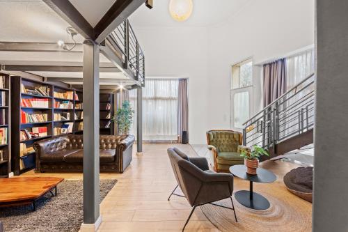 a living room with a couch and chairs and a table at Big family apartment Berlin Treptower Park in Berlin