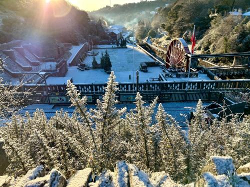 a winter scene of a amusement park with a roller coaster at The Cottage, Bridge House in Laxey