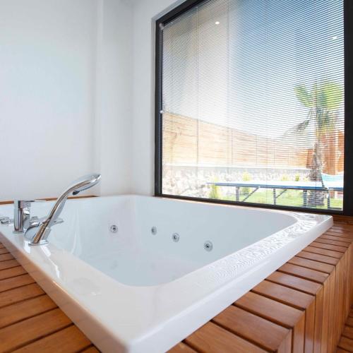 a white bath tub in a room with a window at Villa Bahamas in Kas