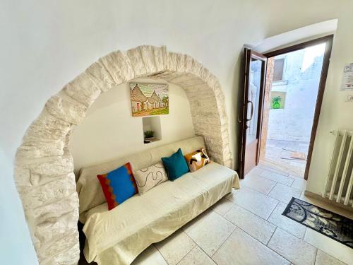 アルベロベッロにあるLuxury Trulli with Terraceの石造りのアーチのある部屋のソファ