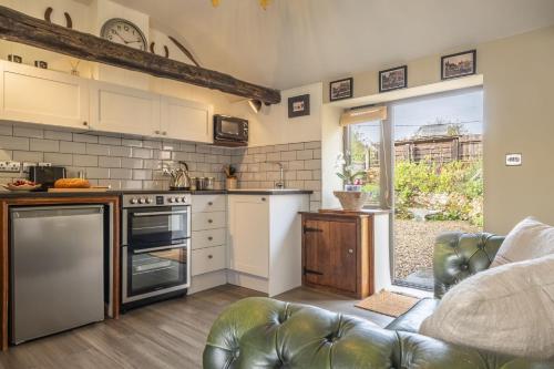 a kitchen with a stove and a couch in a room at The Forge in Edgefield