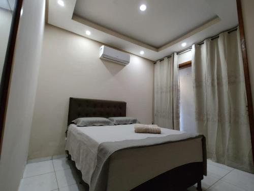 a bedroom with a bed and a window at Chalé Raio de Sol in Marau