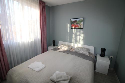 a bedroom with a bed with two pillows on it at Къща за гости Света Марина in Krapets