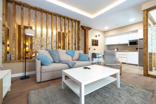 a living room with a couch and a table at Apartamentos LA CAÑADA DE OSMA in El Burgo de Osma