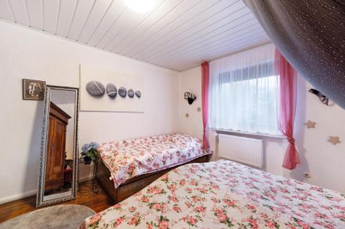 a bedroom with two beds and a mirror and a window at Mole Valley Ranch Fewo1 in Elmlohe