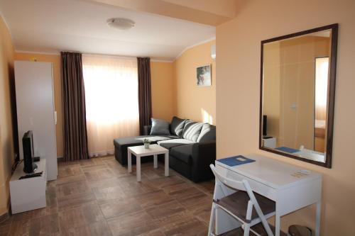 a living room with a couch and a mirror at Къща за гости Света Марина in Krapets