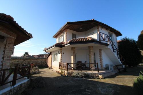 a small white house with a brown roof at Къща за гости Света Марина in Krapets