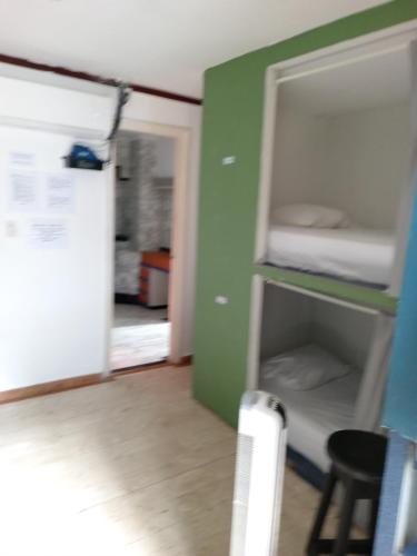 a room with a refrigerator and a bunk bed at Casa hotel in Panama City