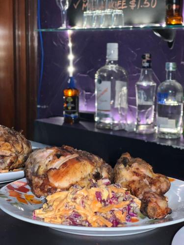 two plates of food on a table with bottles of alcohol at Casa hotel in Panama City