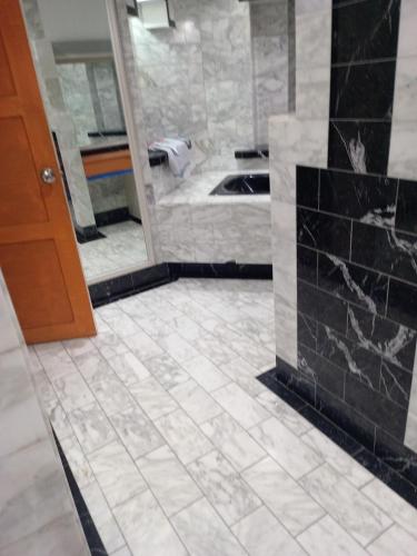 a bathroom with a black and white tile floor at Casa hotel in Panama City