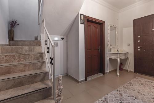 a cat sitting in a hallway next to a staircase at Villa Yazır in Antalya