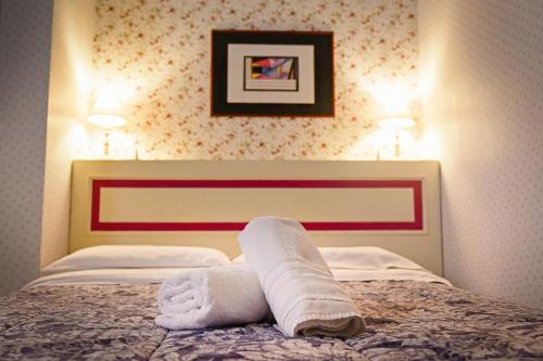 a hotel room with a bed with a towel on it at Al centro Luxury Home in Caserta
