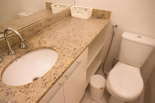 a bathroom with a sink and a toilet at Executive In - Ideal para família in Rio de Janeiro