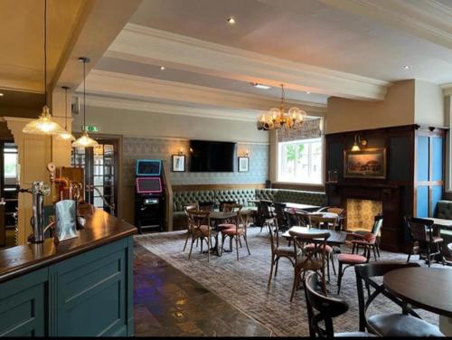 a restaurant with tables and chairs and a bar at The Wheatley Hotel in Doncaster