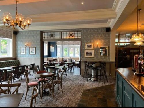 a restaurant with tables and chairs and a bar at The Wheatley Hotel in Doncaster